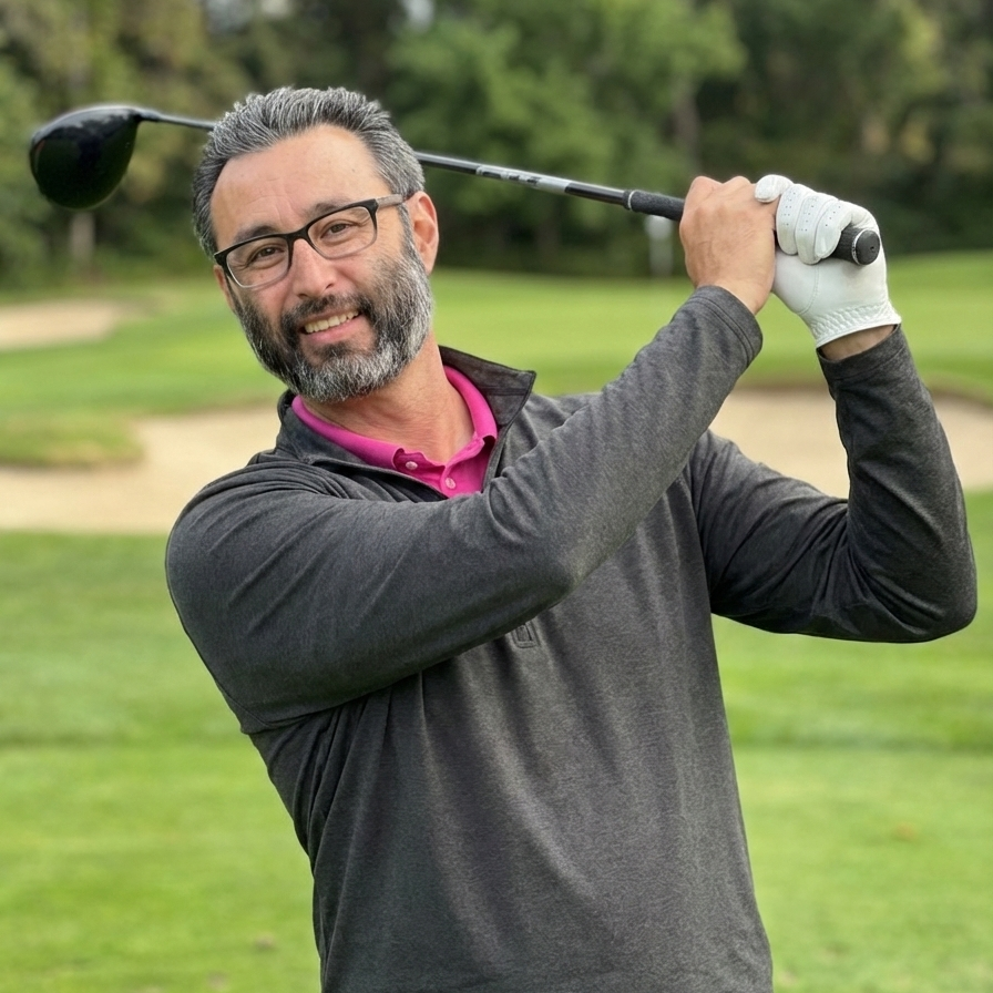 David, owner of DMac Golfs, finishing his golf swing on the course